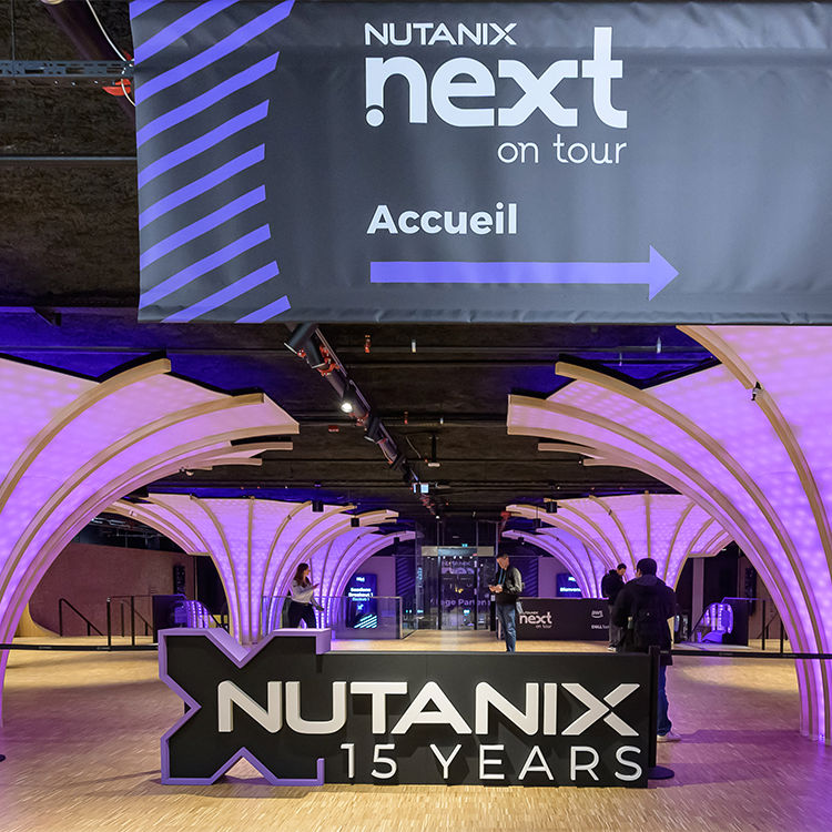 .NEXT on Tour 2024 Paris space interior with branded signage and decorative arches, providing a modern and professional atmosphere.