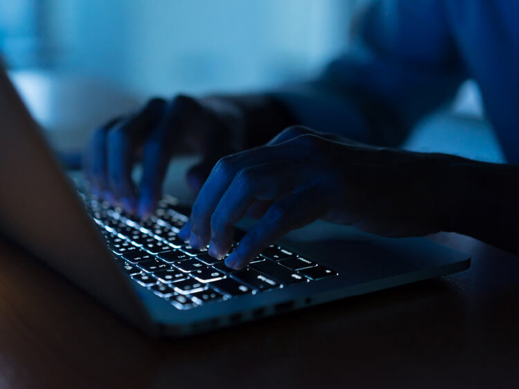 Person typing on laptop